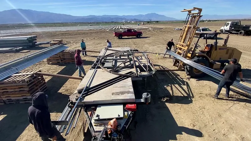 Ferrari Metals hoop-house arch bending machine operating at a commercial farm site